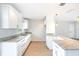 Bright kitchen featuring white cabinets, granite countertops, and stainless steel sink at 1823 8Th E Ave, Bradenton, FL 34208