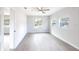 Spacious living room with neutral paint, ceiling fan, and multiple windows at 1823 8Th E Ave, Bradenton, FL 34208