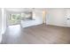 Sunlit living area boasts an open-concept design with updated flooring and a seamless flow into the kitchen at 1823 8Th E Ave, Bradenton, FL 34208