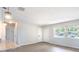 Open-concept living area with modern gray wood floors, fresh paint, and updated lighting fixtures at 1823 8Th E Ave, Bradenton, FL 34208
