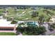 Aerial view of a lush golf course, pool, and clubhouse surrounded by mature trees at 2005 47Th Street W Ct, Bradenton, FL 34209