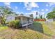 Serene backyard featuring a screened-in patio, well-maintained lawn, and partial fence at 2005 47Th Street W Ct, Bradenton, FL 34209