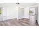 Bedroom with wood-look flooring, closet with folding doors, and a door leading to the outside of home at 2005 47Th Street W Ct, Bradenton, FL 34209
