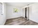 Clean, minimal bedroom with light wood-look flooring, a window, and a closet with folding doors at 2005 47Th Street W Ct, Bradenton, FL 34209