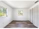 This bedroom has wood-look floors, multiple windows, and closet with folding doors at 2005 47Th Street W Ct, Bradenton, FL 34209