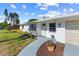 Close up of home featuring well-kept lawn and landscaping, neutral color scheme, and freshly painted driveway at 2005 47Th Street W Ct, Bradenton, FL 34209