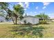 Inviting home featuring a well-manicured lawn, mature palm tree, and side yard entry at 2005 47Th Street W Ct, Bradenton, FL 34209