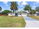 Charming single-story home featuring a well-manicured lawn and beautiful palm trees in a sunny neighborhood at 2005 47Th Street W Ct, Bradenton, FL 34209