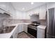 Well-lit kitchen features stainless steel appliances, sleek countertops, and ample cabinet space for the modern home at 2005 47Th Street W Ct, Bradenton, FL 34209