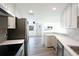 Contemporary kitchen features stainless steel appliances, sleek countertops, and modern cabinets, flowing into living space at 2005 47Th Street W Ct, Bradenton, FL 34209