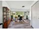 Bright office with large windows, wood-look flooring, storage shelving, and a door to hallway at 2005 47Th Street W Ct, Bradenton, FL 34209