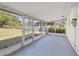 Enclosed patio with screen windows providing tranquil views of the backyard and outdoor access at 2005 47Th Street W Ct, Bradenton, FL 34209