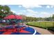 Community playground with climbing structure, near tennis courts and large green field at 2005 47Th Street W Ct, Bradenton, FL 34209