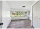 A well-lit sunroom offers a full wall of windows and light wood-look flooring, with door to outside at 2005 47Th Street W Ct, Bradenton, FL 34209