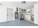 Utility area with a washing machine, dryer, water heater, and door to the garage at 2005 47Th Street W Ct, Bradenton, FL 34209
