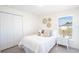 Comfortable bedroom features a full closet, neutral colors and a bright window at 21077 Baffin Ave, Port Charlotte, FL 33954