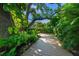 Lush backyard garden with a charming wooden deck and a tree swing, set amidst vibrant greenery at 2124 Wisteria St, Sarasota, FL 34239