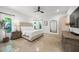 Light-filled bedroom with natural light, neutral décor, ceiling fan, and view of the exterior landscape at 2124 Wisteria St, Sarasota, FL 34239