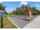 Outdoor exercise area featuring modern fitness equipment on a paved surface, with surrounding greenery and clear signage at 2124 Wisteria St, Sarasota, FL 34239