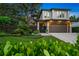 Stunning two-story home with lush landscaping, a modern design, and a finished two car garage at 2124 Wisteria St, Sarasota, FL 34239