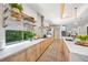 Bright kitchen with natural wood cabinets, quartz countertops, and a large undermount sink at 2124 Wisteria St, Sarasota, FL 34239