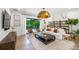 Stylish living room with modern furniture, decorative shelving, and large windows offering natural light at 2124 Wisteria St, Sarasota, FL 34239