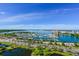 Breathtaking aerial view of a marina, boasting numerous boats, lush greenery, and a vibrant cityscape under a clear blue sky at 2124 Wisteria St, Sarasota, FL 34239