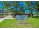 Arlington Park sign in front of recreational building and pool, surrounded by lush greenery at 2124 Wisteria St, Sarasota, FL 34239