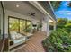 Inviting patio area with comfortable seating, ceiling fans, and lush green plants all around the home at 2124 Wisteria St, Sarasota, FL 34239