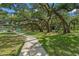 Park with large trees, picnic tables, a playground, and a paved pathway, perfect for Gathering outings and recreation at 2124 Wisteria St, Sarasota, FL 34239