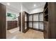 Spacious walk-in closet with built-in shelving and drawers for optimal organization, with a window for natural light at 2124 Wisteria St, Sarasota, FL 34239