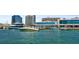 Picturesque view from a boat showcasing a marina with luxury yachts and modern buildings along the waterfront under a sunny sky at 2124 Wisteria St, Sarasota, FL 34239