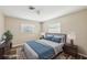 Virtually staged bedroom with wood-look flooring, neutral paint and a well-lit and comforting space at 217 Giotto Dr, Nokomis, FL 34275