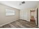Bright bedroom featuring wood-look flooring, neutral walls, closet and natural light from the window at 217 Giotto Dr, Nokomis, FL 34275