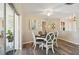 Cozy dining room featuring stylish decor, wood-look flooring, and a modern ceiling fan at 217 Giotto Dr, Nokomis, FL 34275