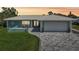Charming single-story home featuring a pristine tile roof, paver driveway and lush green lawn at 217 Giotto Dr, Nokomis, FL 34275