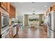 Open kitchen with stainless appliances, granite counters, and a large dining area at 217 Giotto Dr, Nokomis, FL 34275