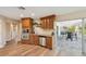 Eat-in kitchen featuring stainless appliances, wood cabinetry, and access to screened in patio at 217 Giotto Dr, Nokomis, FL 34275