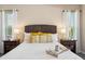 Comfortable main bedroom with neutral decor, decorative pillows, and two bedside lamps at 217 Giotto Dr, Nokomis, FL 34275