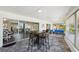 Enclosed patio with large windows and sliding glass doors, stone floors, and seating area at 217 Giotto Dr, Nokomis, FL 34275