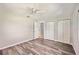 Bedroom with wood-look flooring, closet and a view to the front yard through the window at 219 Marlin Dr, Punta Gorda, FL 33950
