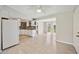 Open-concept kitchen features white cabinets, tile floors and access to a backyard patio at 219 Marlin Dr, Punta Gorda, FL 33950