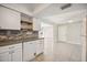 Bright kitchen with white cabinets, open shelving, and a view to the patio at 219 Marlin Dr, Punta Gorda, FL 33950