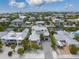Stunning aerial view of a coastal home with a metal roof, lush landscaping, and canal access, capturing the essence of waterfront living at 224 Chilson Ave, Anna Maria, FL 34216