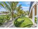 Backyard featuring a putting green, lush landscaping, and waterfront access at 224 Chilson Ave, Anna Maria, FL 34216