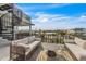 Relaxing outdoor balcony with comfortable seating and a view of neighborhood rooftops at 224 Chilson Ave, Anna Maria, FL 34216