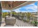 Outdoor balcony featuring comfortable seating and views of the waterfront and palm trees at 224 Chilson Ave, Anna Maria, FL 34216
