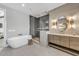 Serene bathroom with a soaking tub, glass-enclosed shower, and modern vanity with metallic accents at 224 Chilson Ave, Anna Maria, FL 34216