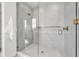 Modern bathroom featuring a glass shower with marble tile and gold fixtures at 224 Chilson Ave, Anna Maria, FL 34216