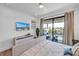 Comfortable bedroom with balcony access, neutral tones, and bright, natural lighting at 224 Chilson Ave, Anna Maria, FL 34216